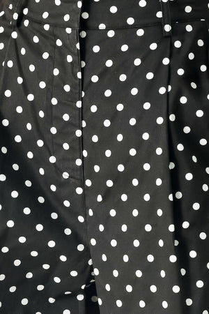 Close up of black polka dot pants with front closure, side pockets and wide leg | FREEMARKET