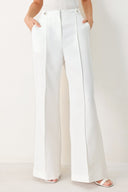 Woman wearing white wide-leg pants with side pockets and front closure | FREEMARKET