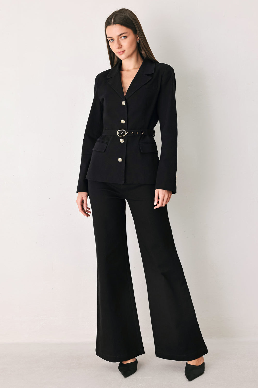 Woman wearing a pair of high waisted black denim flared jeans | FREEMARKET