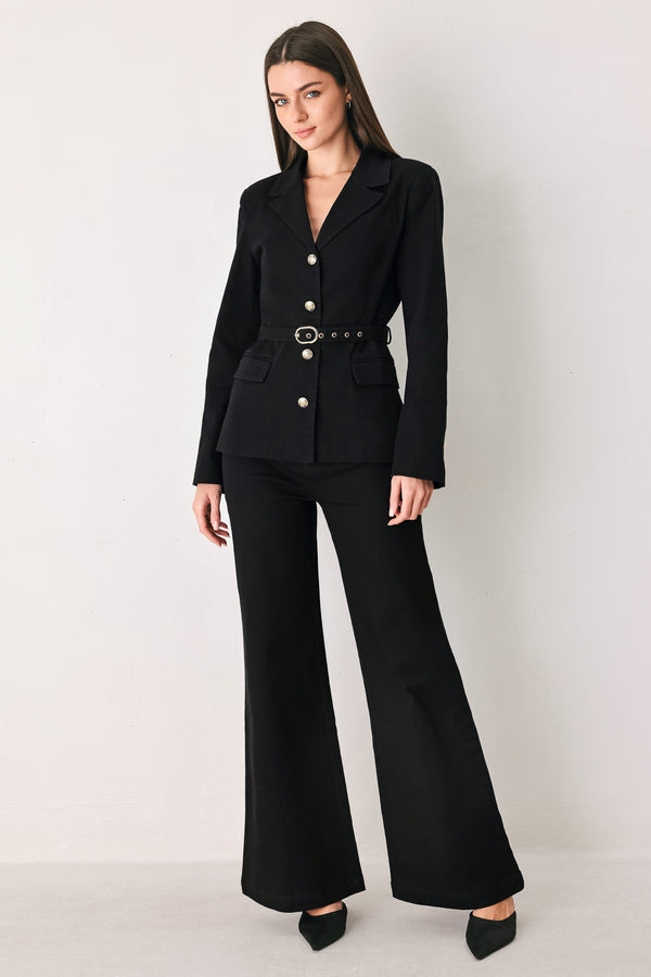 Woman wearing a pair of high waisted black denim flared jeans | FREEMARKET