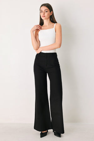 Woman wearing a pair of high waisted black denim flared jeans | FREEMARKET