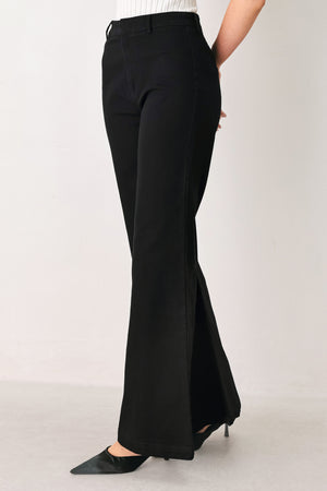 Woman wearing a pair of high waisted black denim flared jeans | FREEMARKET