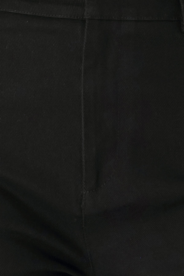 Woman wearing a pair of high waisted black denim flared jeans | FREEMARKET