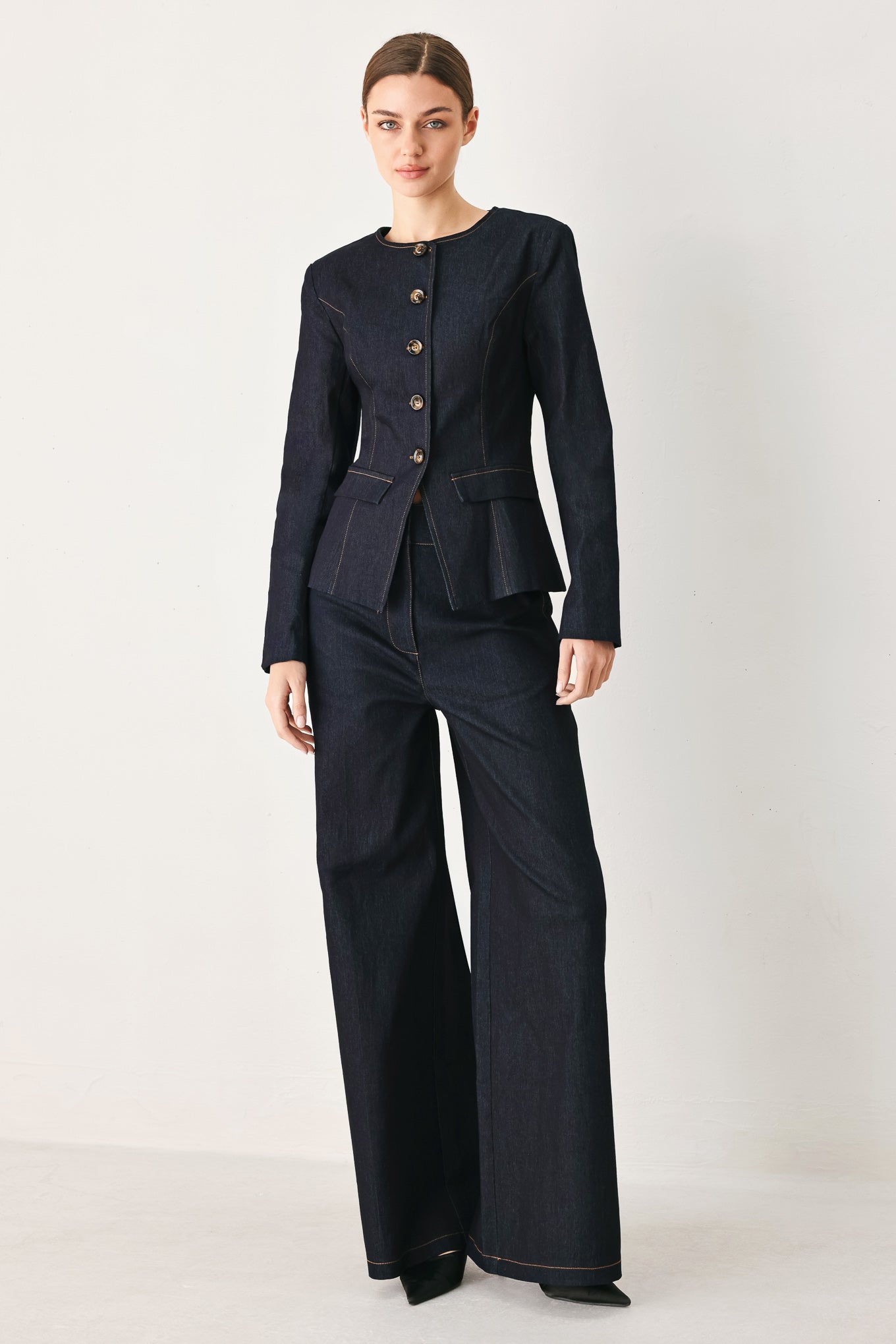 Woman wearing dark denim navy blue wide-leg pants with gold buttons | FREEMARKET