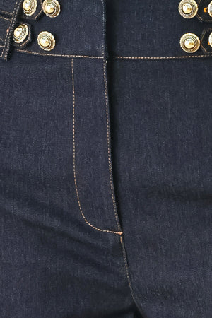 Woman wearing dark denim navy blue wide-leg pants with gold buttons | FREEMARKET