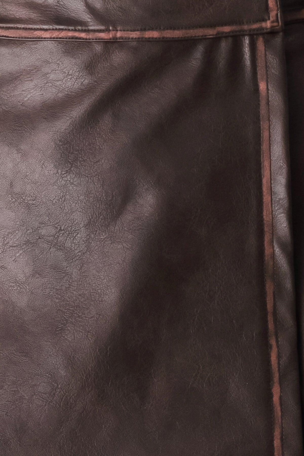 Woman wearing a brown faux leather skort with buttons along the pocket seam | FREEMARKET