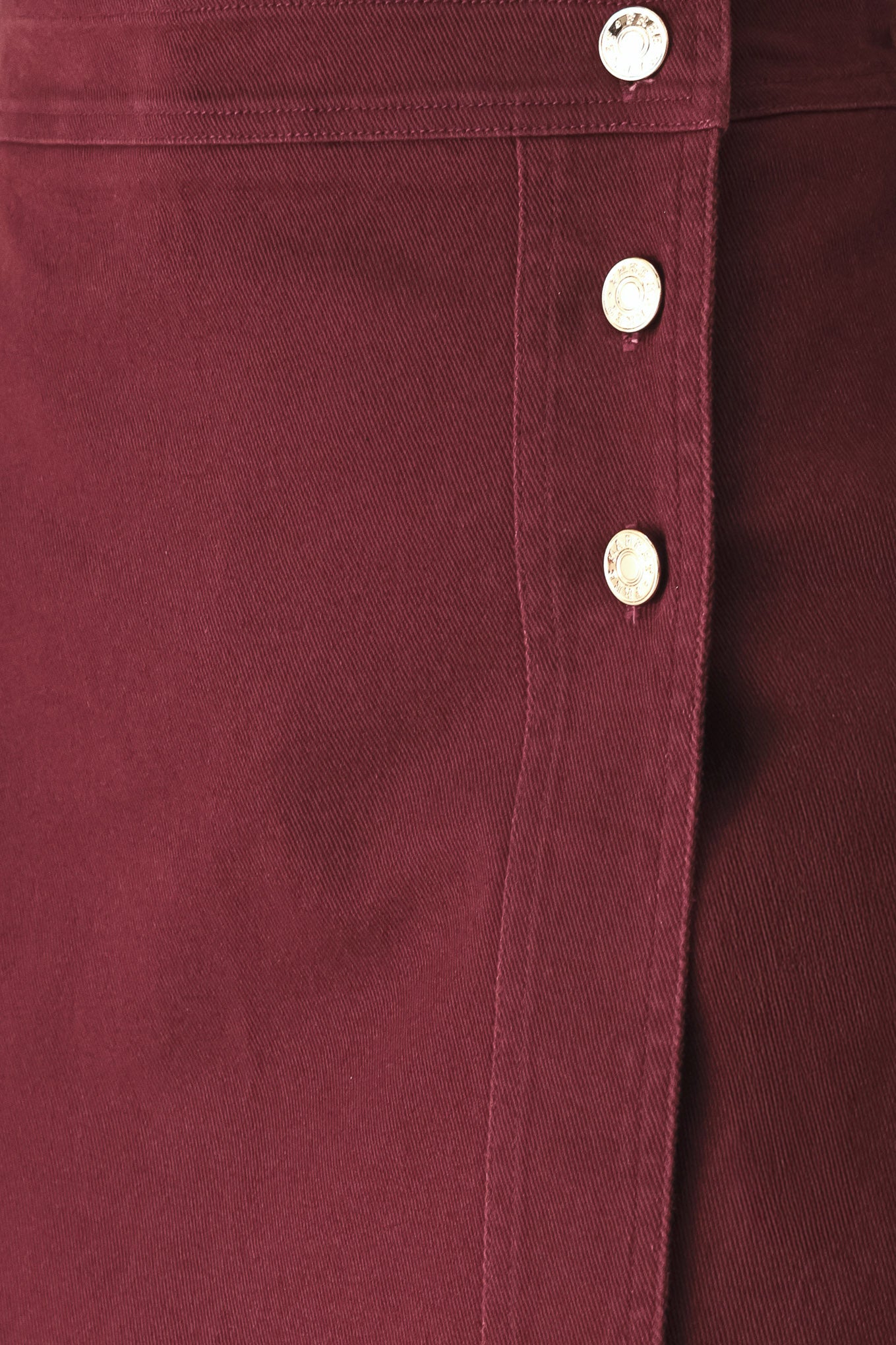 Woman wearing a dark burgundy mini skort with front buttons | FREEMARKET