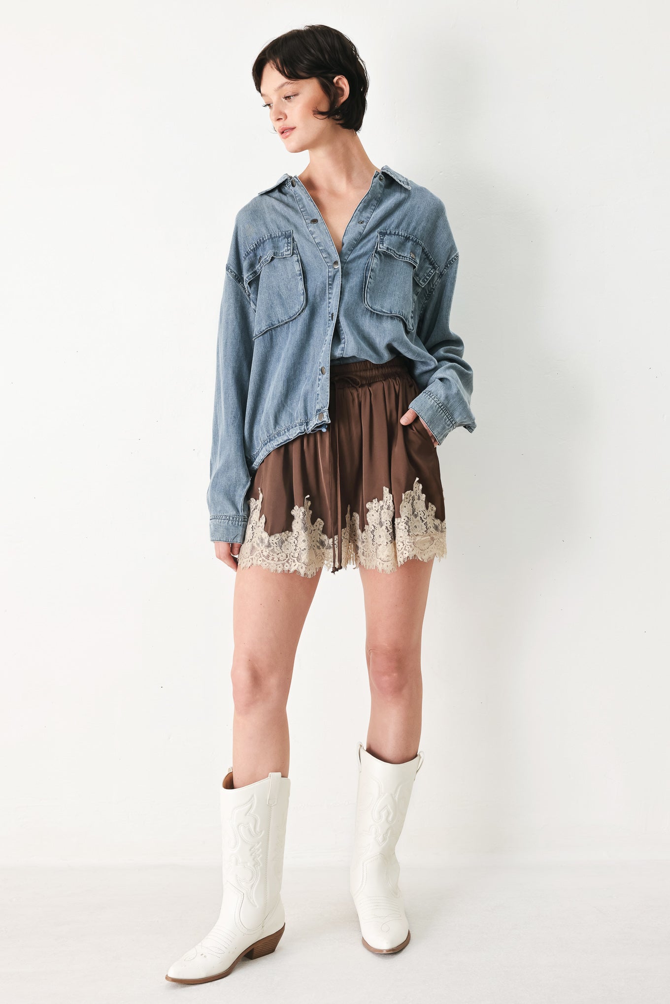 Woman wearing brown shorts with lace trim and elastic waistband | FREEMARKET