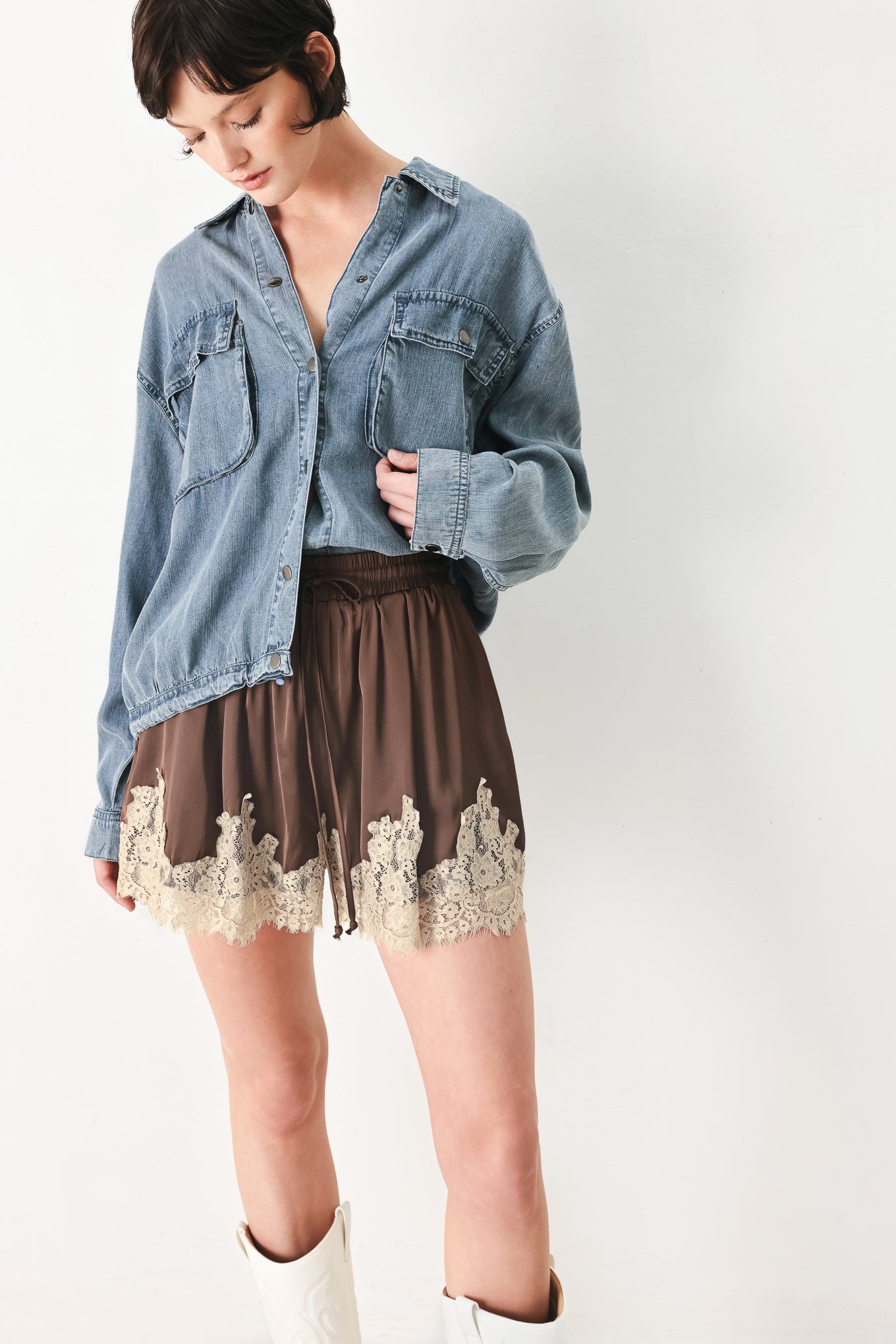 Woman wearing brown shorts with lace trim and elastic waistband | FREEMARKET