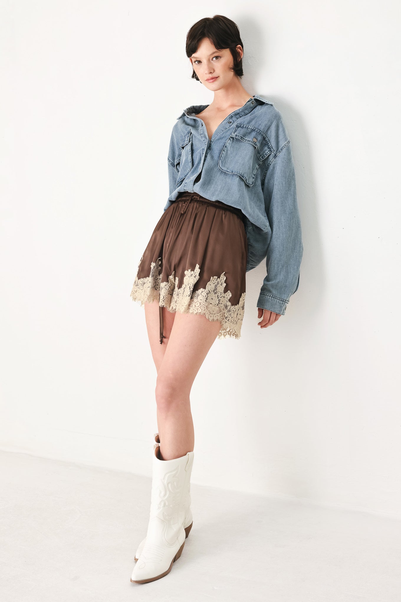 Woman wearing brown shorts with lace trim and elastic waistband | FREEMARKET