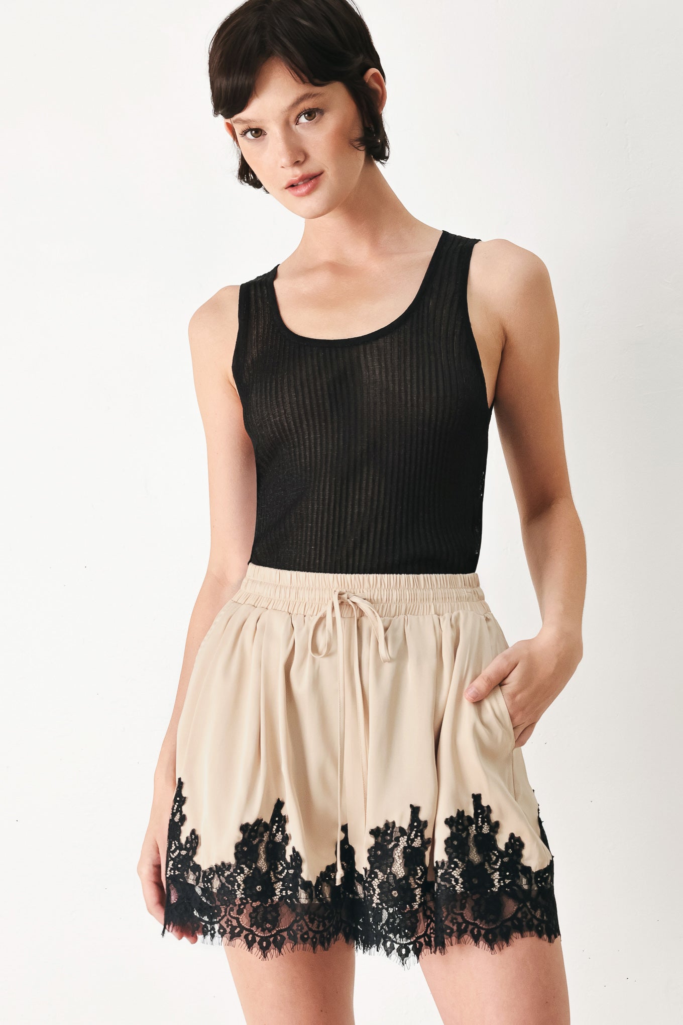 Woman wearing beige shorts with lace trim and elastic waistband | FREEMARKET