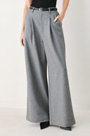 Woman wearing gray wide-leg pant with front closure, single pleat, pockets, and black belt | FREEMARKET