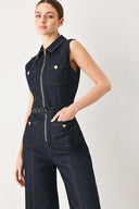 Woman wearing a dark blue denim sleeveless, wide-leg jumpsuit featuring collar, front zipper closure, and pockets | FREEMARKET