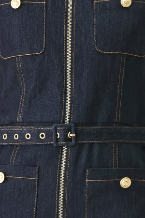 Woman wearing a dark blue denim sleeveless, wide-leg jumpsuit featuring collar, front zipper closure, and pockets | FREEMARKET