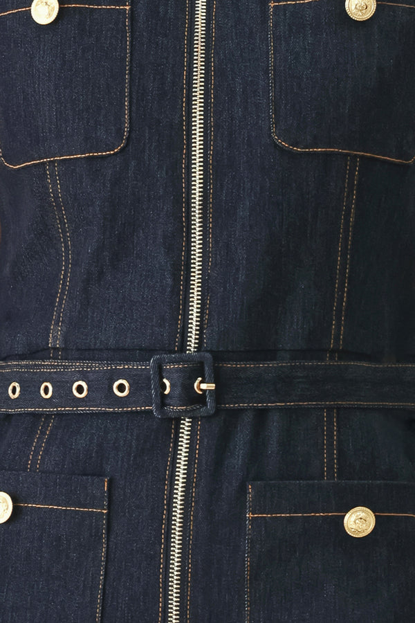 Woman wearing a dark blue denim sleeveless, wide-leg jumpsuit featuring collar, front zipper closure, and pockets | FREEMARKET
