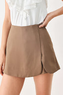 Woman wearing a camel brown skort with side zipper closure | FREEMARKET