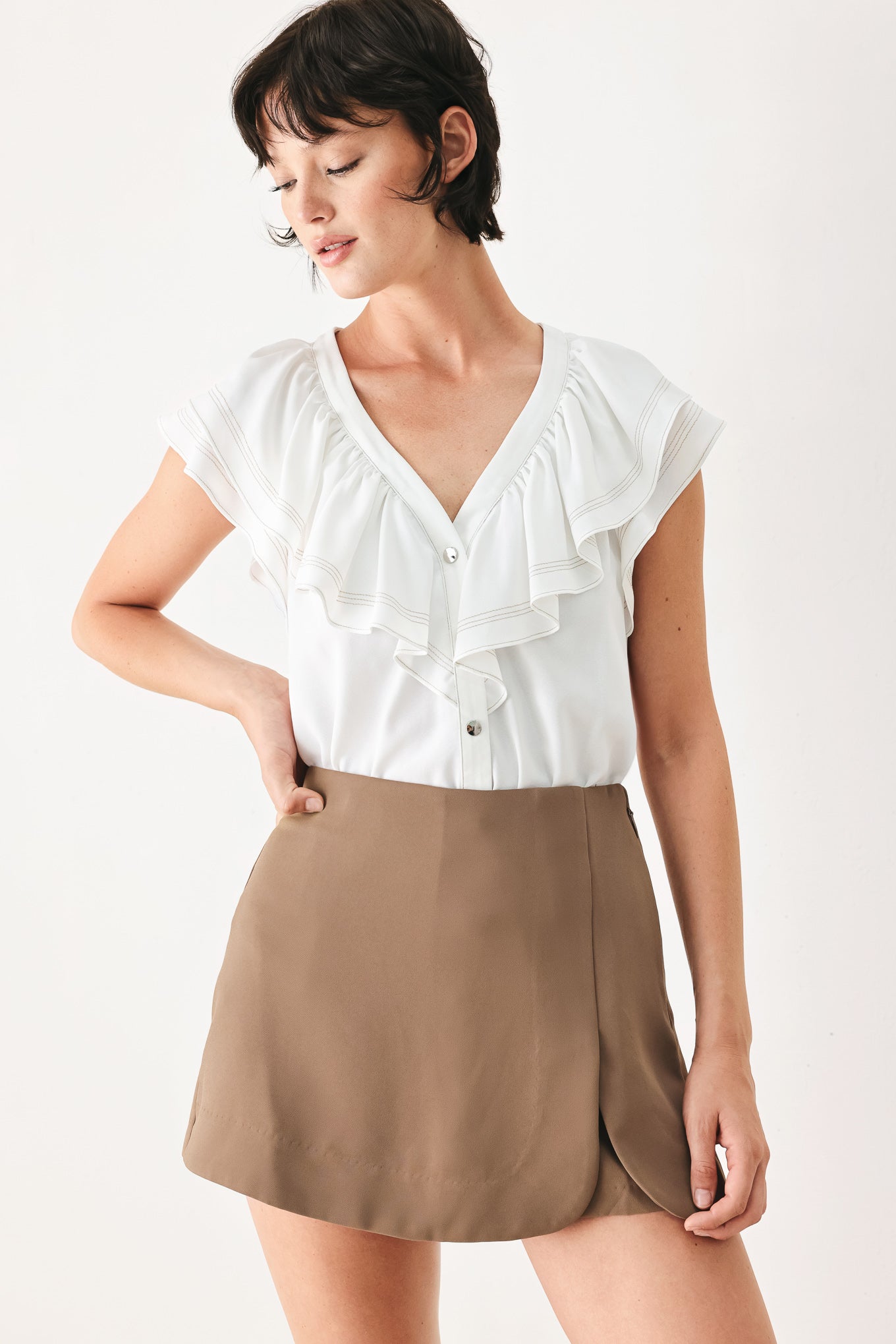 Woman wearing a camel brown skort with side zipper closure | FREEMARKET