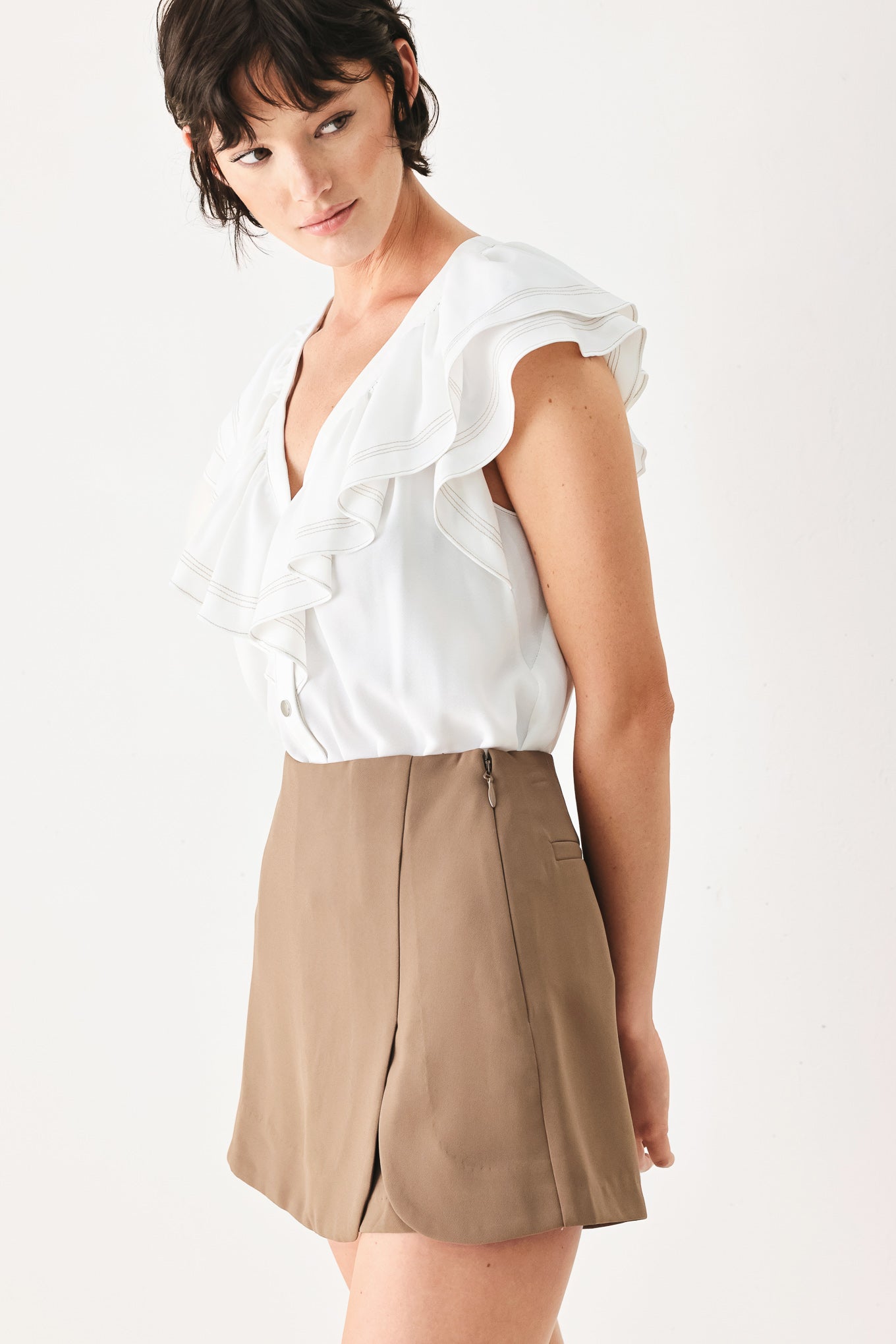 Woman wearing a camel brown skort with side zipper closure | FREEMARKET