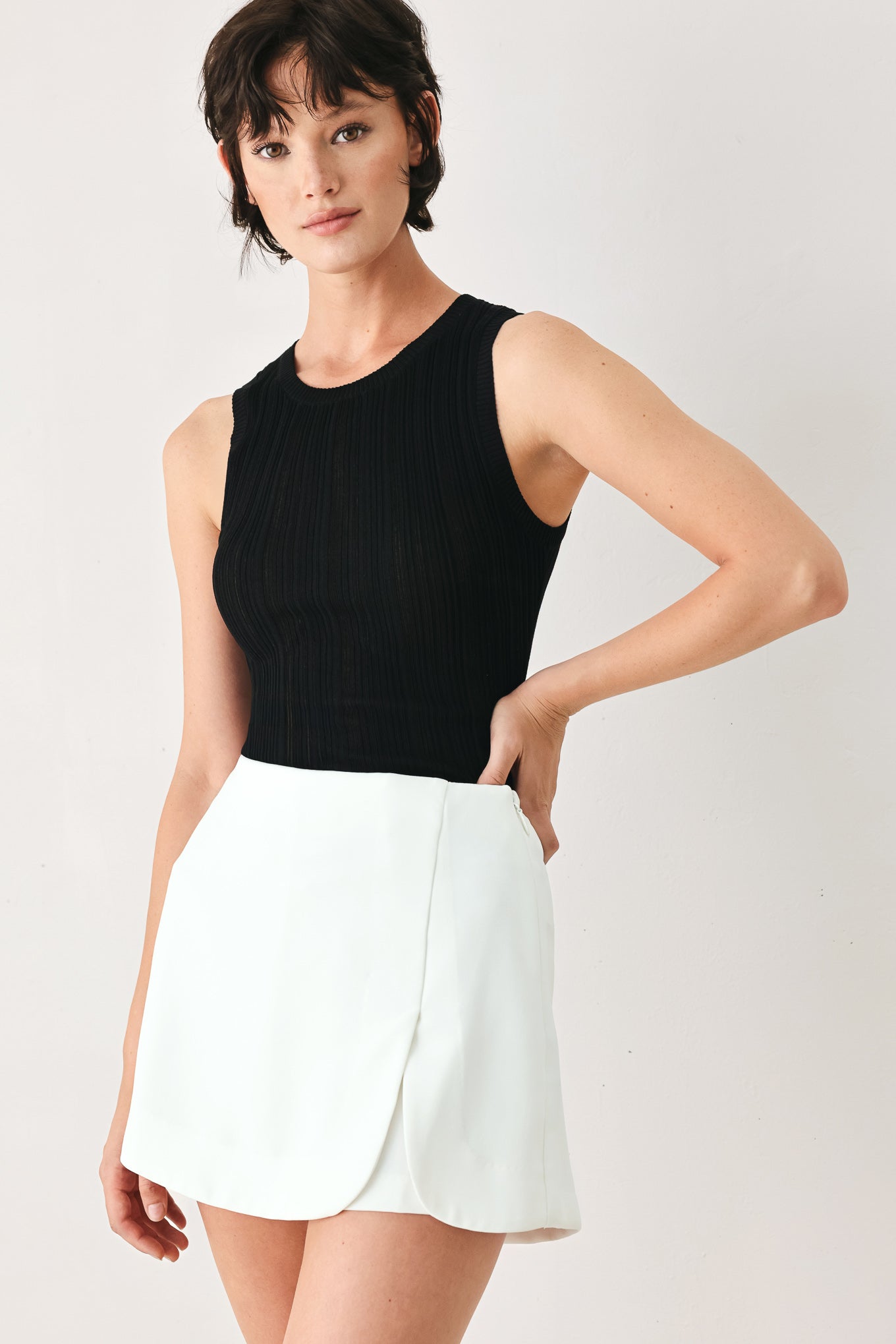 Woman wearing a white skort with side zipper closure | FREEMARKET