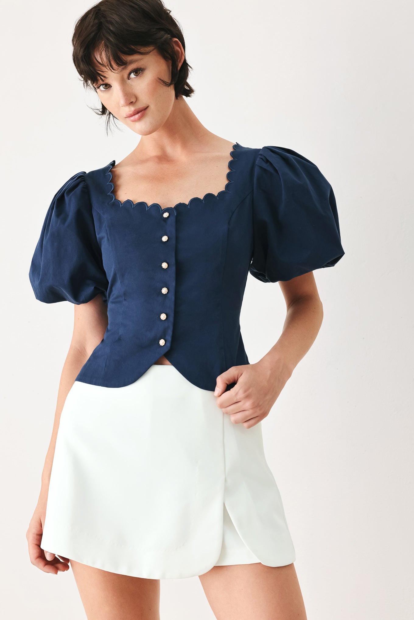 Woman wearing a white skort with side zipper closure | FREEMARKET