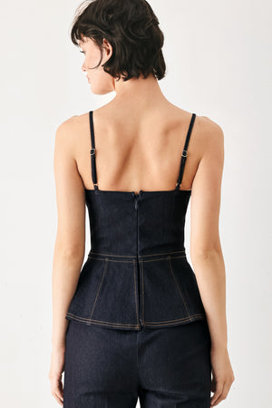 Woman wearing a dark denim jumpsuit with a peplum top and wide-leg pants style | FREEMARKET