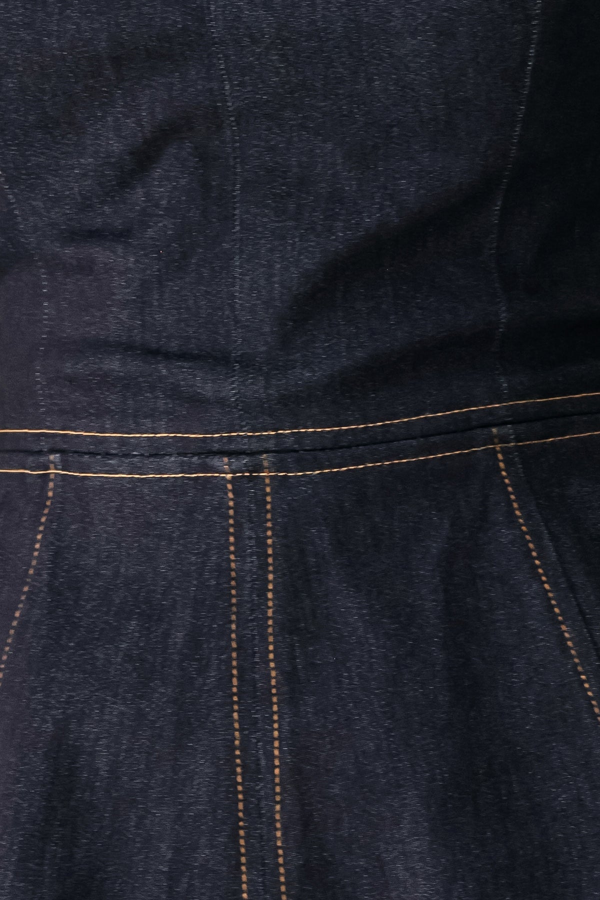 Woman wearing a dark denim jumpsuit with a peplum top and wide-leg pants style | FREEMARKET