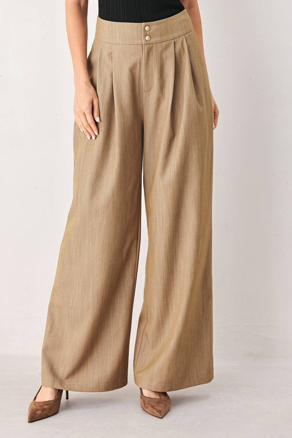 A model wearing high-waisted, wide-leg trousers in a light tan color with buttons | FREEMARKET