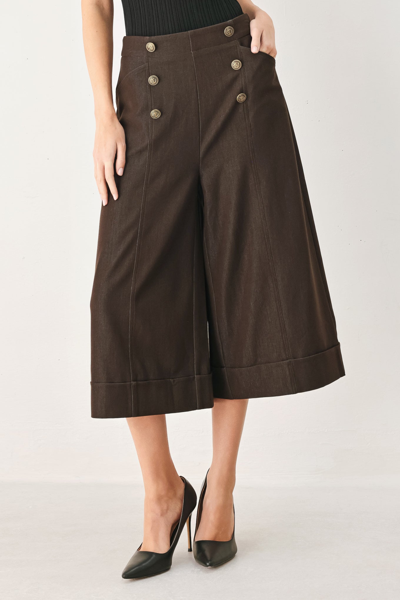 Woman wearing brown solid woven culotte pant with front button detail and back zipper closure | FREEMARKET