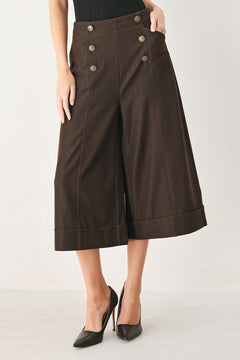Woman wearing brown solid woven culotte pant with front button detail and back zipper closure | FREEMARKET