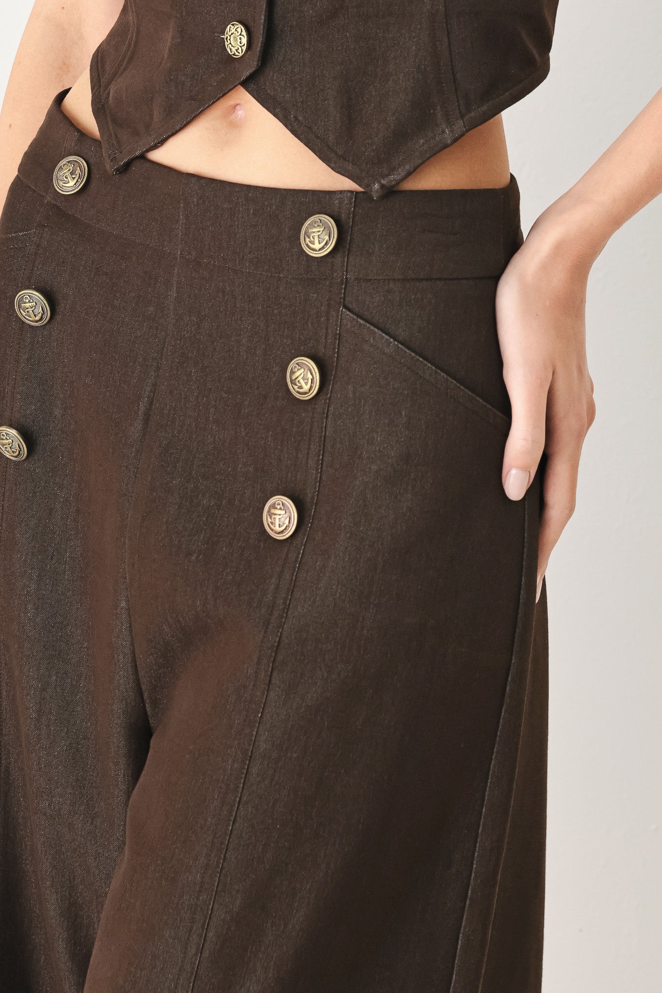 Woman wearing brown solid woven culotte pant with front button detail and back zipper closure | FREEMARKET
