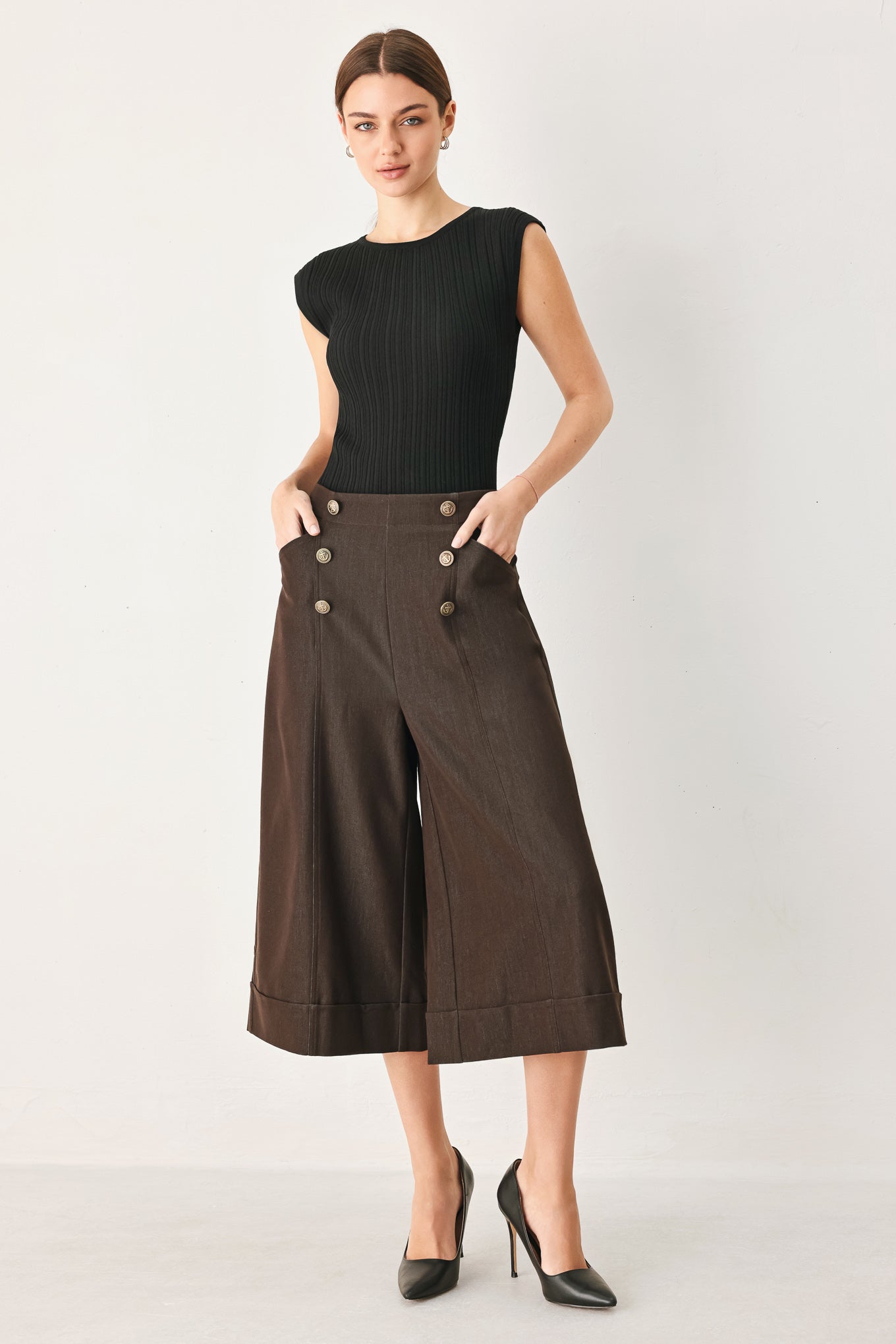 Woman wearing brown solid woven culotte pant with front button detail and back zipper closure | FREEMARKET