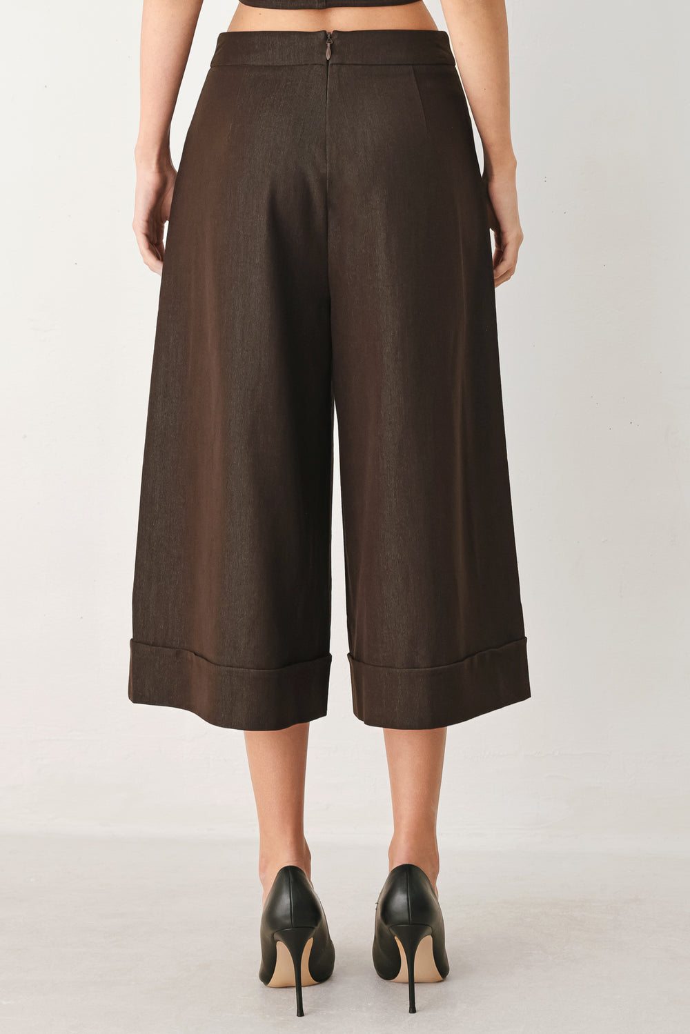 Woman wearing brown solid woven culotte pant with front button detail and back zipper closure | FREEMARKET