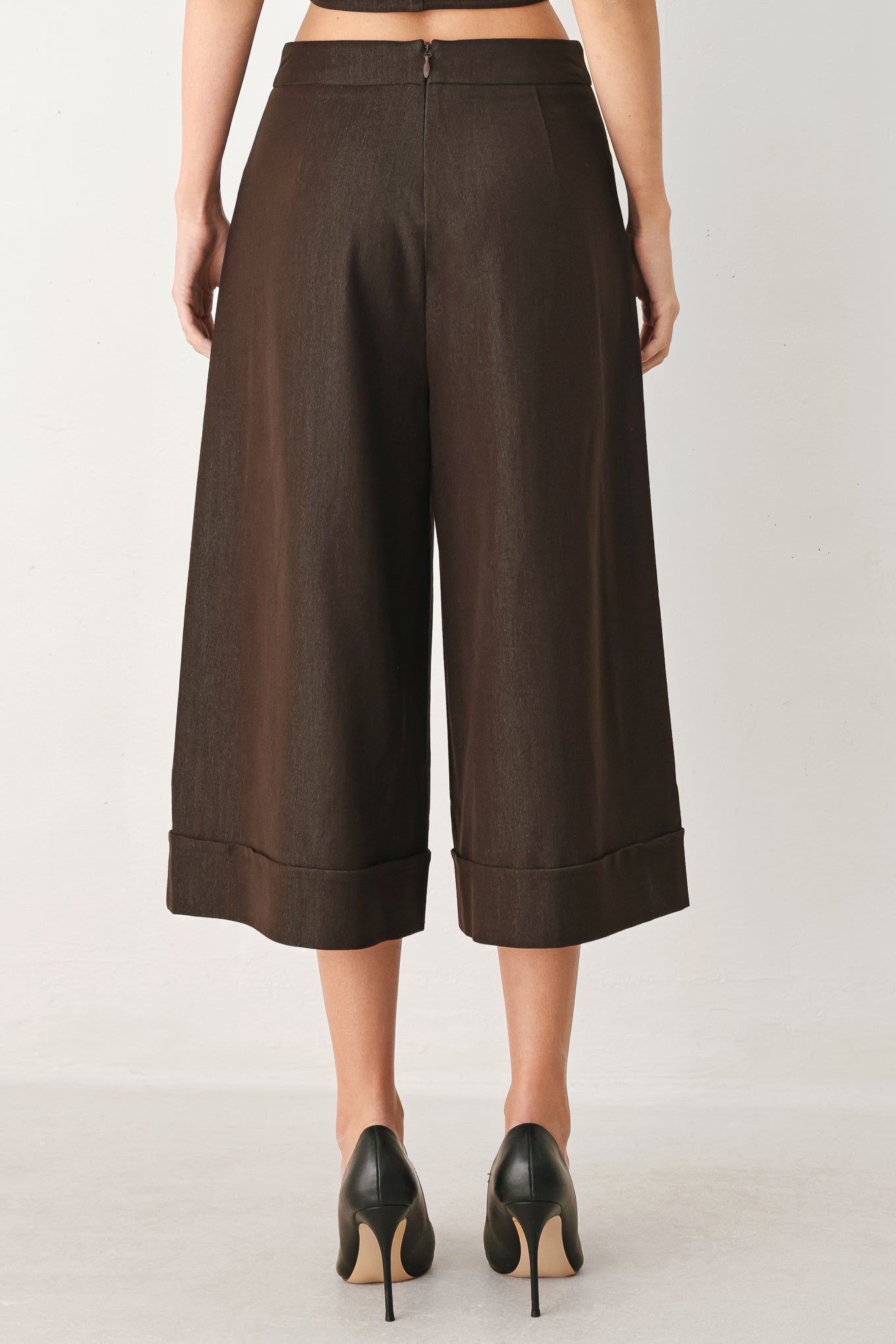 Woman wearing brown solid woven culotte pant with front button detail and back zipper closure | FREEMARKET