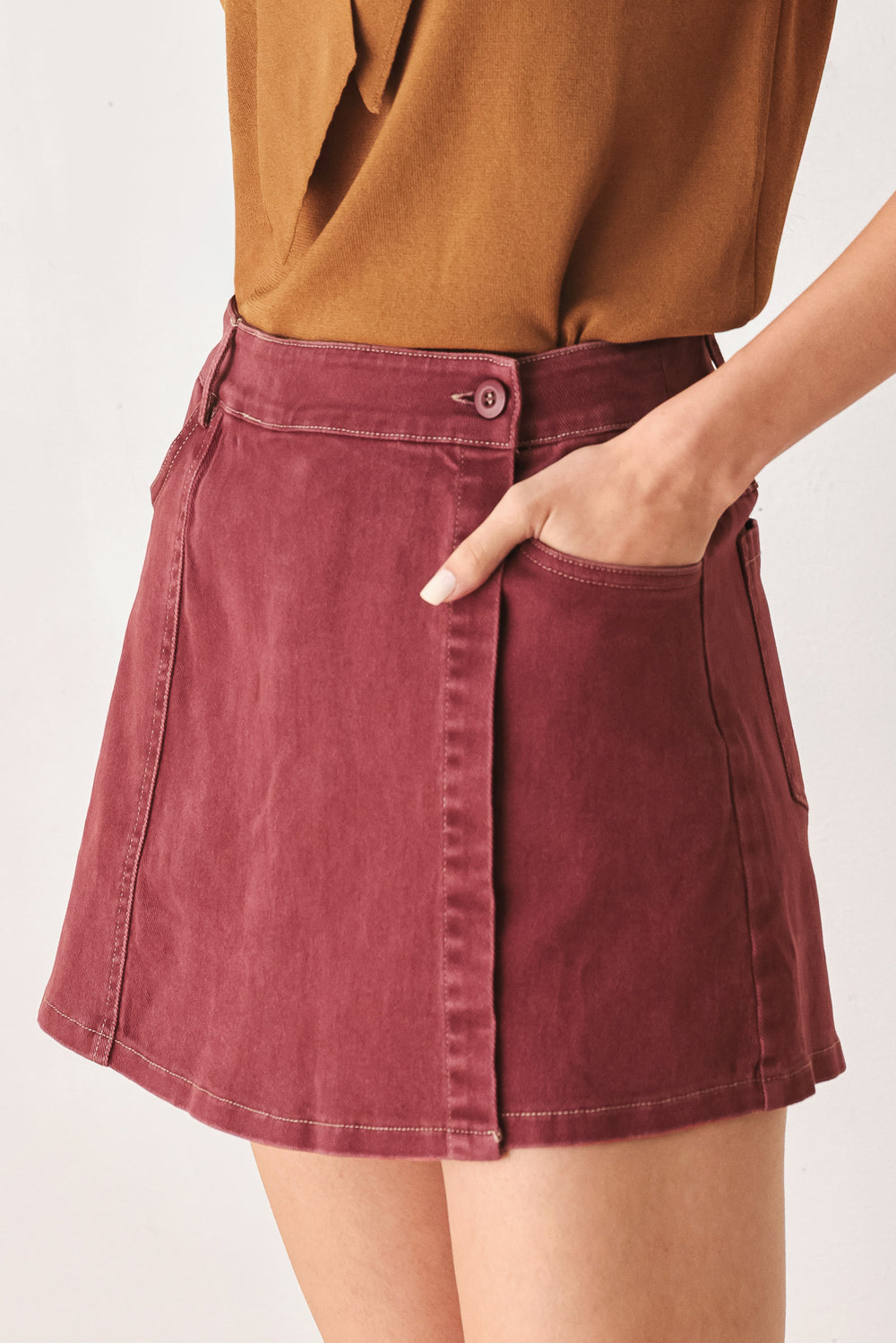 A woman wearing a wine colored mini skort | FREEMARKET