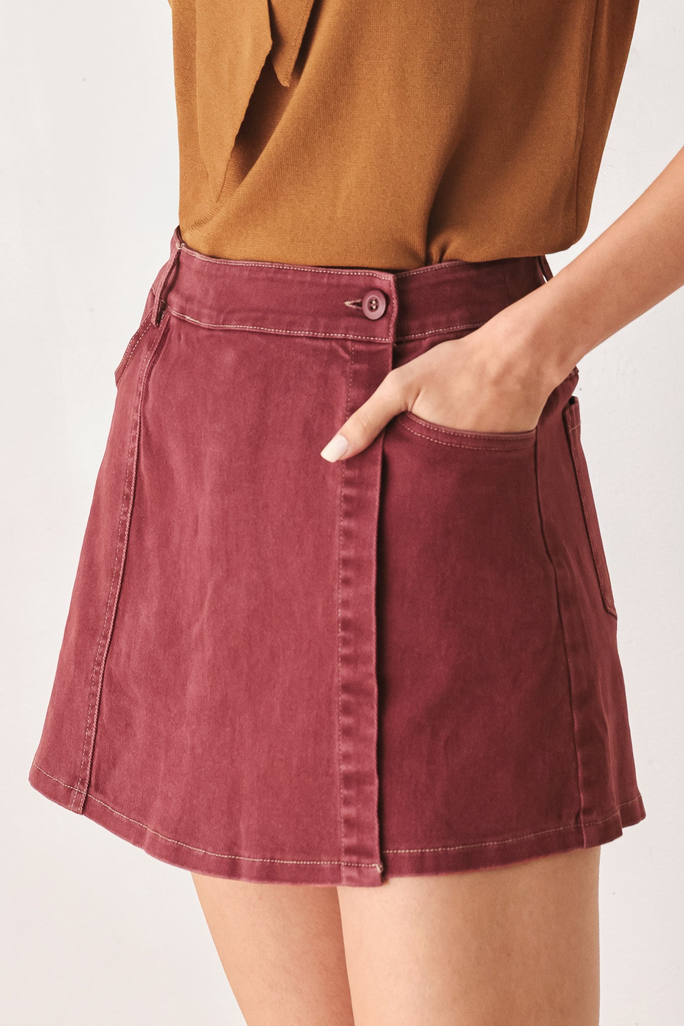 A woman wearing a wine colored mini skort | FREEMARKET