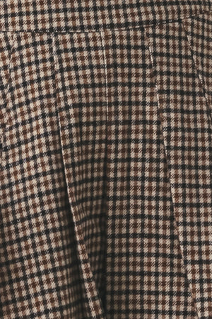 Close-up of a brown, beige, and black checkered fabric texture.