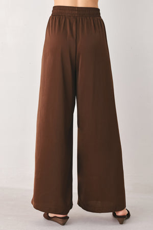 Woman wearing brown wide-leg drawstring pants | FREEMARKET