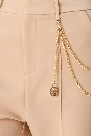 Woman wearing camel beige wide-leg pants with a chain detail on the side | FREEMARKET