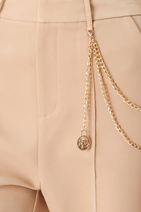 Woman wearing camel beige wide-leg pants with a chain detail on the side | FREEMARKET