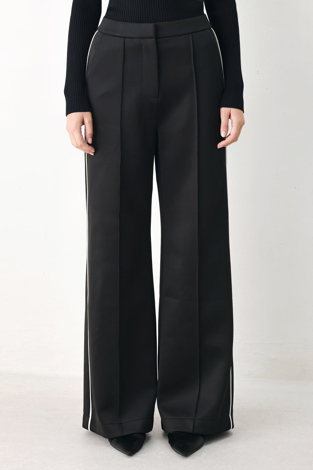 Model wearing brown wide-leg trousers with white side stripes | FREEMARKET