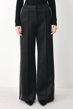 Model wearing black wide-leg trousers with white side stripes | FREEMARKET