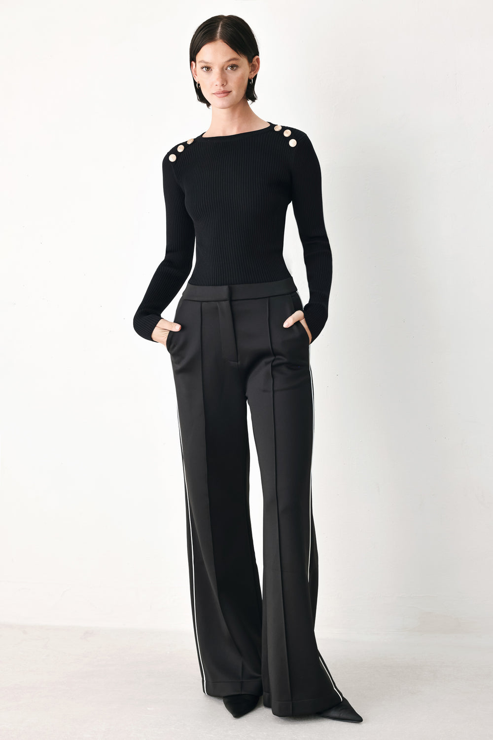 Model wearing brown wide-leg trousers with white side stripes | FREEMARKET