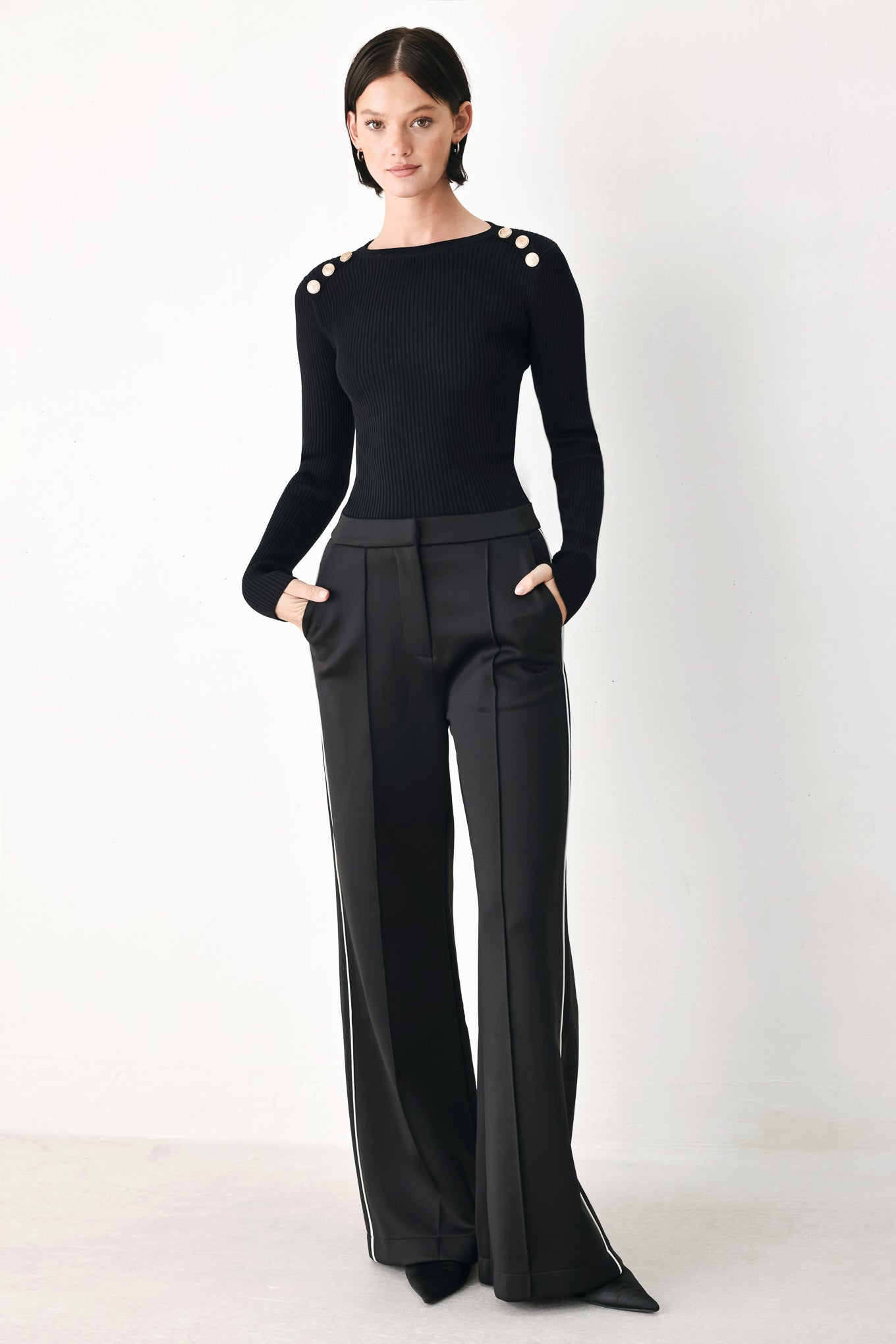 Model wearing black wide-leg trousers with white side stripes | FREEMARKET