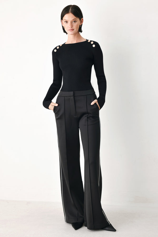 Model wearing black wide-leg trousers with white side stripes | FREEMARKET