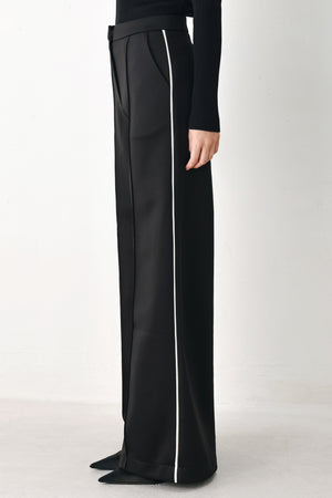 Model wearing black wide-leg trousers with white side stripes | FREEMARKET