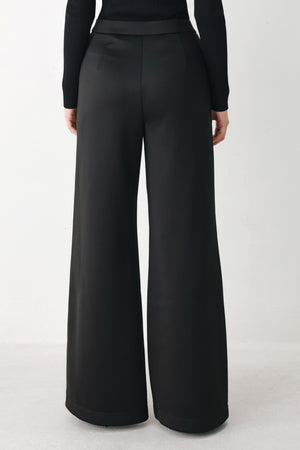 Model wearing black wide-leg trousers with white side stripes | FREEMARKET