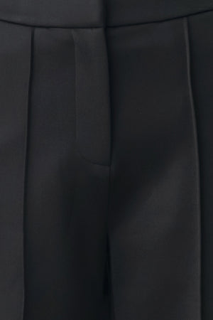 Model wearing black wide-leg trousers with white side stripes | FREEMARKET