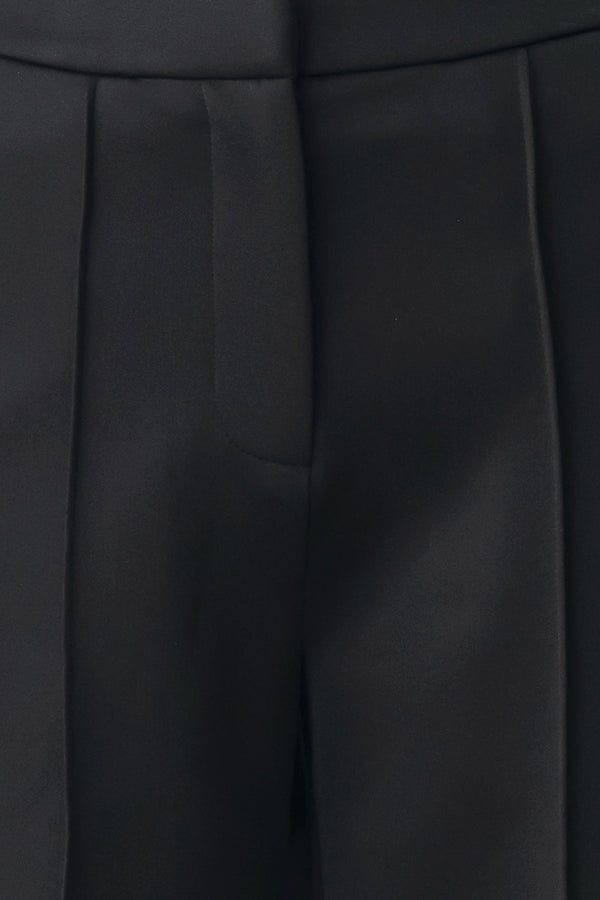 Model wearing black wide-leg trousers with white side stripes | FREEMARKET