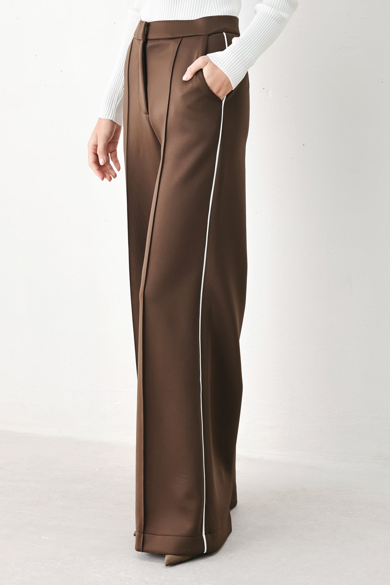 Model wearing brown wide-leg trousers with white side stripes | FREEMARKET