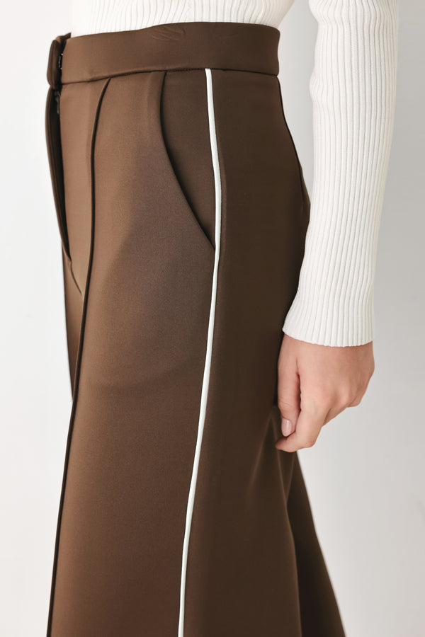 Model wearing brown wide-leg trousers with white side stripes | FREEMARKET